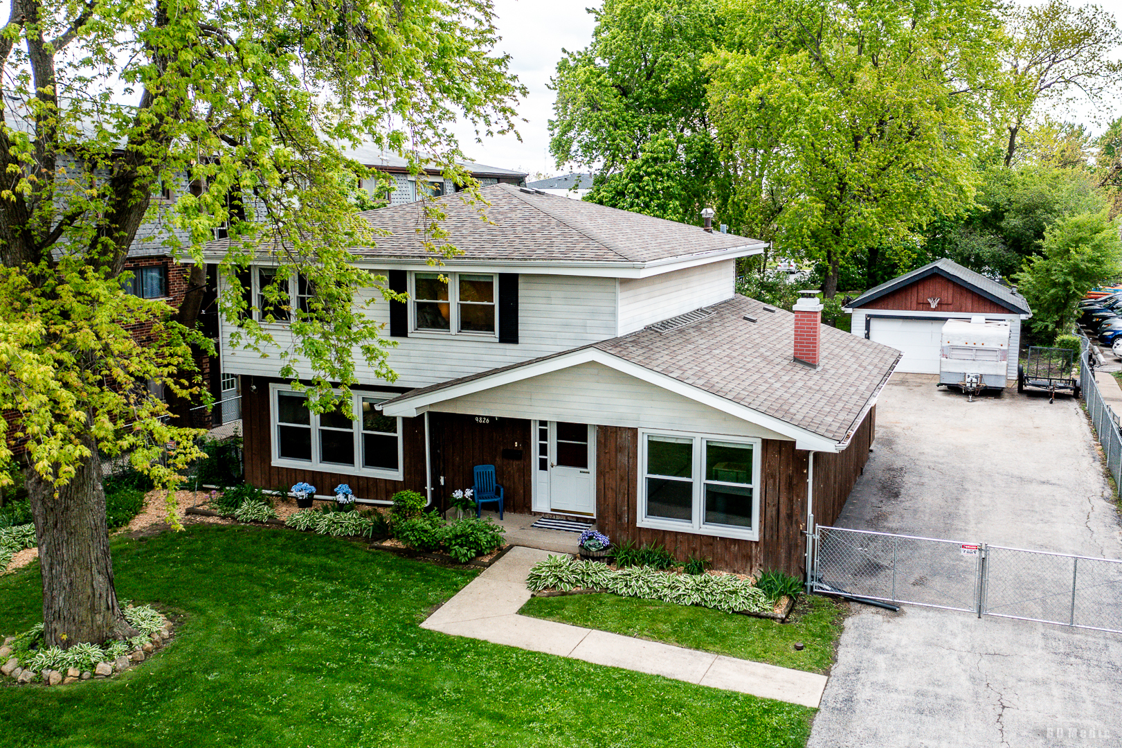9826 Nottingham Avenue Chicago Ridge, IL 60415 - Photo 31 of 35 a front view of a house with a garden and porch