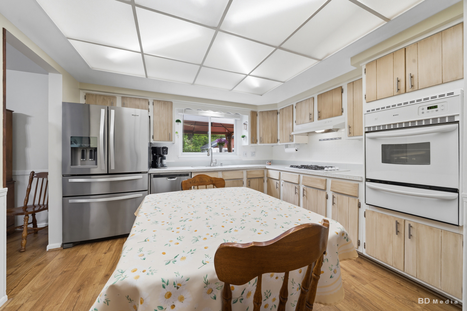9826 Nottingham Avenue Chicago Ridge, IL 60415 - Photo 9 of 35 a kitchen with stainless steel appliances granite countertop a refrigerator a stove a sink dishwasher and white cabinets with wooden floor