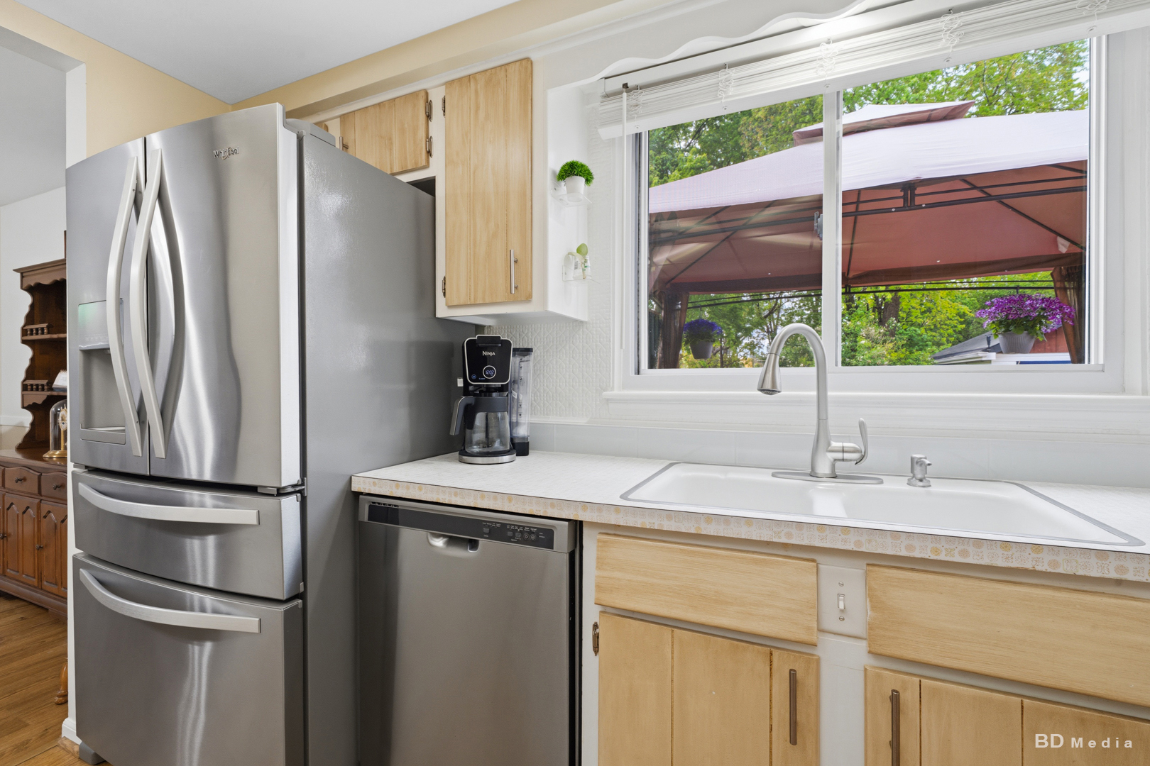 9826 Nottingham Avenue Chicago Ridge, IL 60415 - Photo 10 of 35 a kitchen with kitchen island a counter top space and a large window