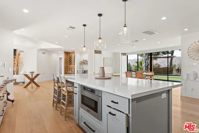 a kitchen with stainless steel appliances kitchen island a large island in the center