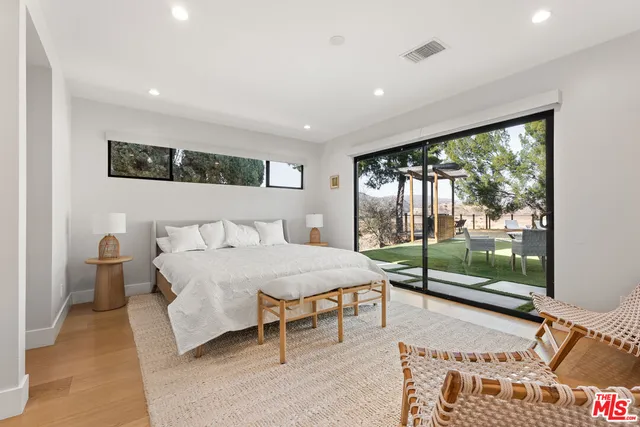 a bedroom with a bed and large window