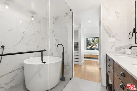 a bathroom with a sink a bathtub and shower