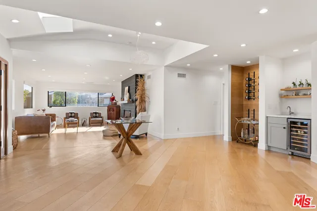 a view of a room with furniture and wooden floor