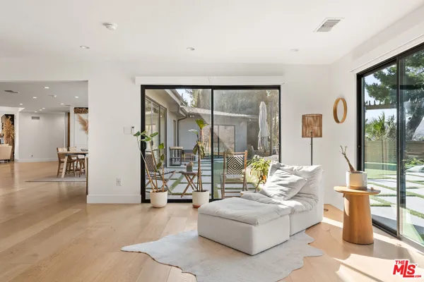 a living room with furniture and large windows