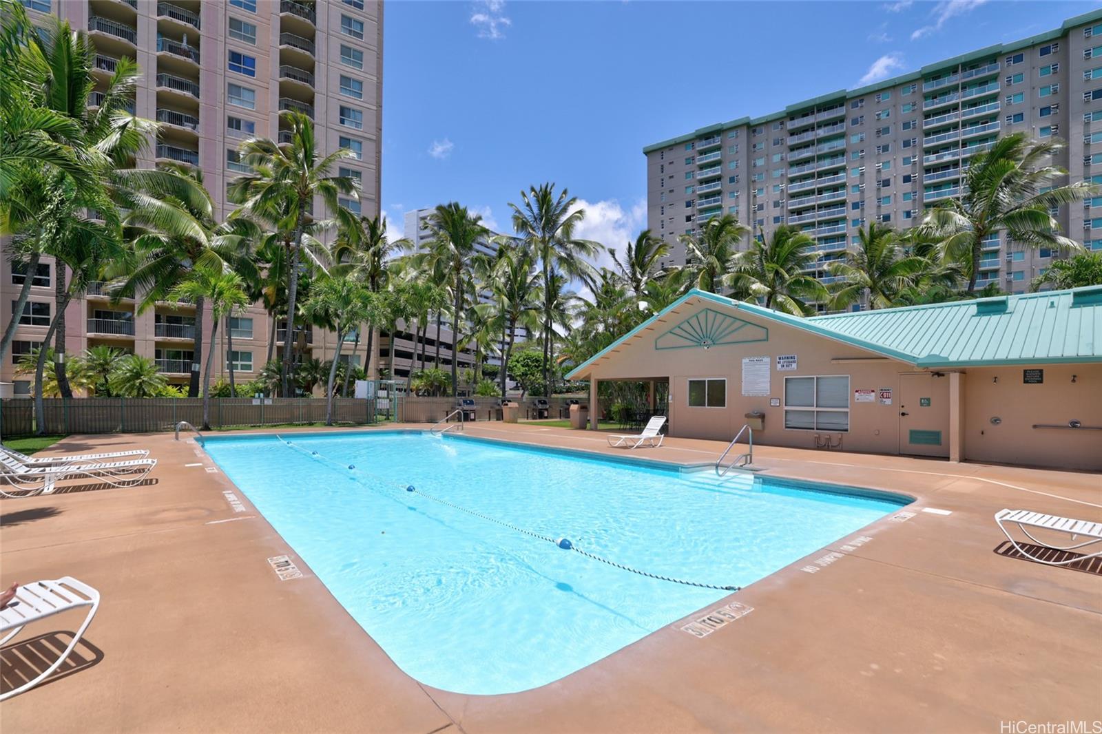 3009 Ala Makahala Place, Unit 1804 Honolulu, HI 96818 - Photo 16 of 20 a view of a house with pool and a yard