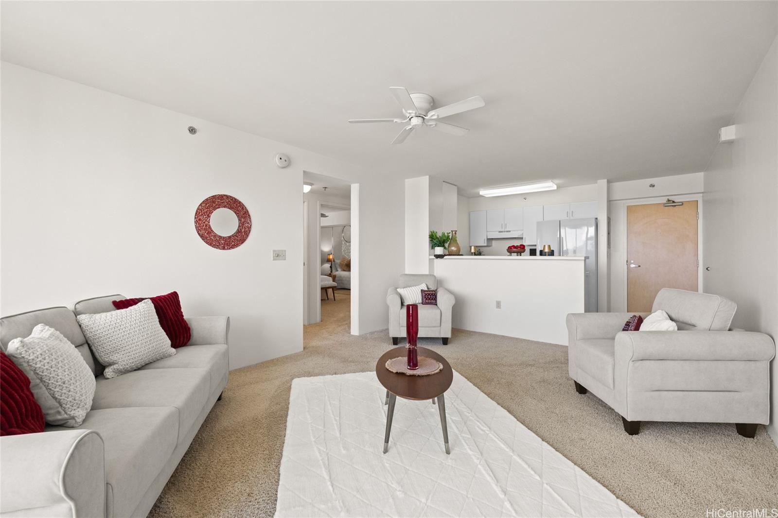3009 Ala Makahala Place, Unit 1804 Honolulu, HI 96818 - Photo 2 of 20 a living room with furniture and kitchen view