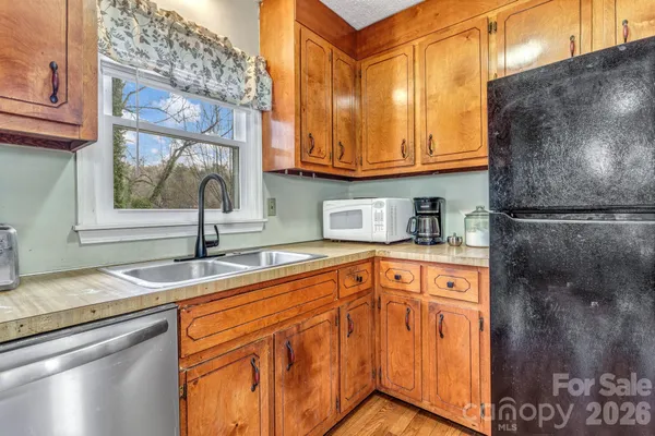 a kitchen with granite countertop a sink and cabinets