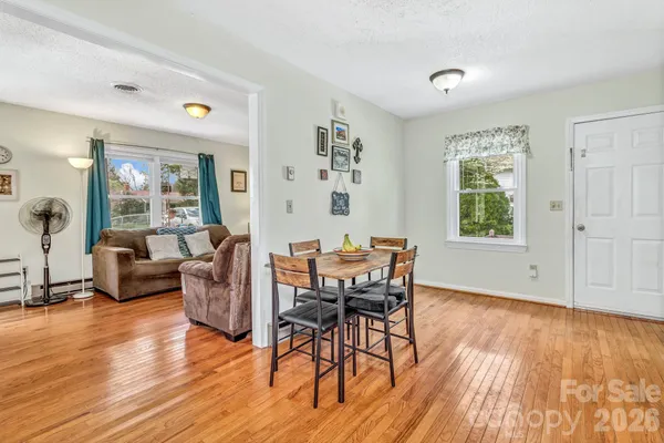a view of a livingroom with furniture window and wooden floor