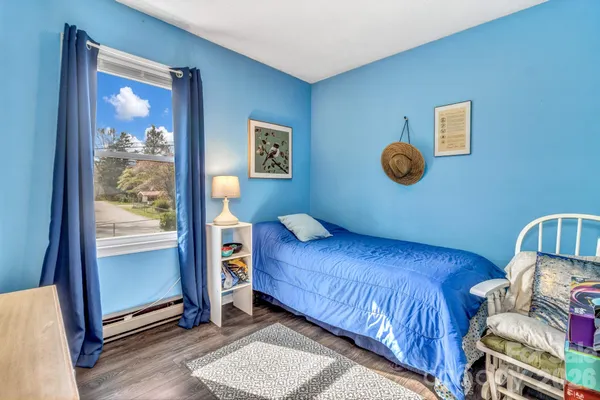 a bedroom with a bed and window