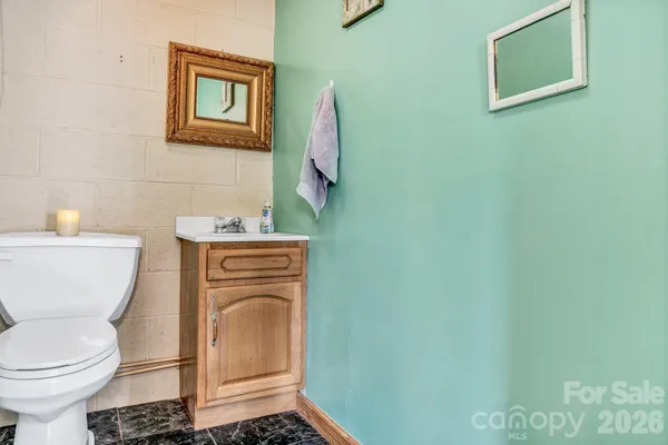 a bathroom with a sink a toilet and a mirror