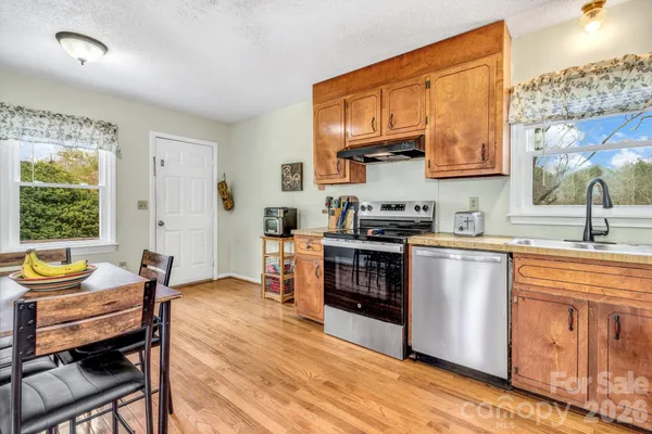 a kitchen with stainless steel appliances kitchen island granite countertop a sink and cabinets