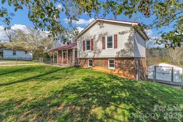 a front view of a house with a yard table and chairs