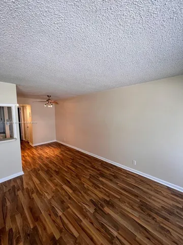 a view of a room with wooden floor