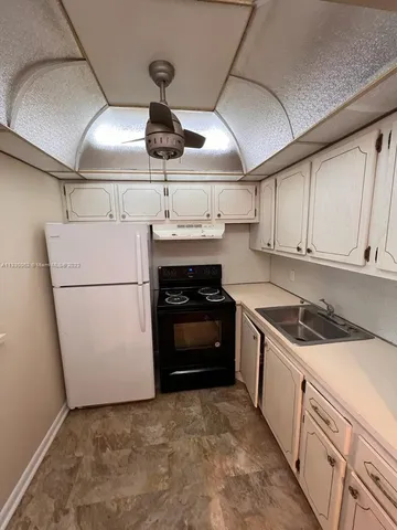 a kitchen with a stove and a refrigerator
