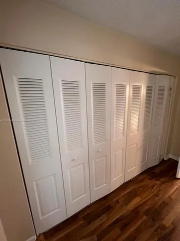 a view of front door with wooden floor