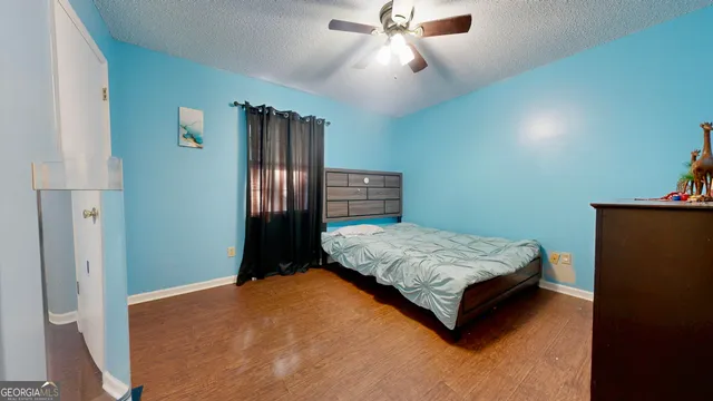 a bedroom with a bed dresser and a window