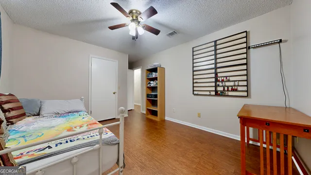 a bedroom with furniture and a chandelier