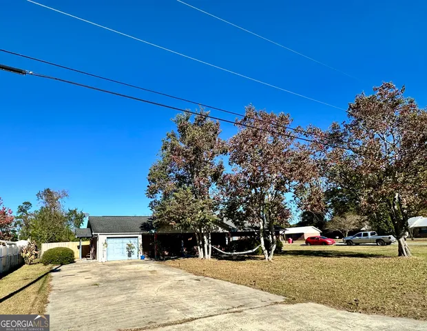 a wooden house with trees in front of it