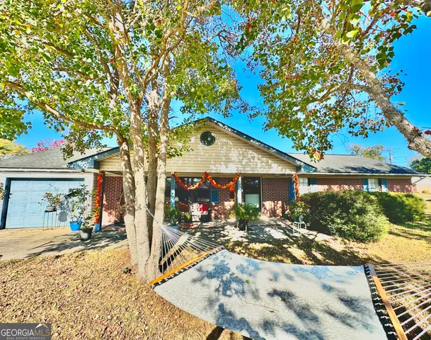 a view of swimming pool with lawn chairs under an umbrella