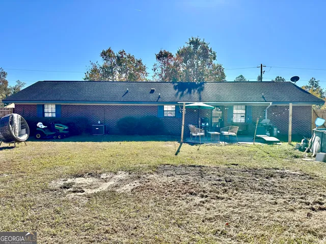 a backyard of a house with table and chairs