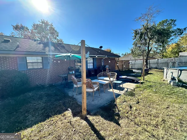 a backyard of a house with yard and outdoor seating