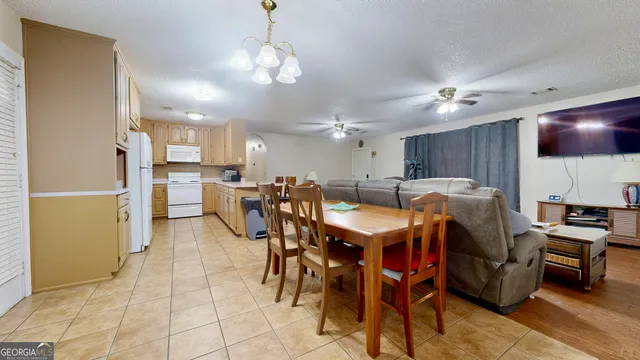 a large kitchen with a table and chairs