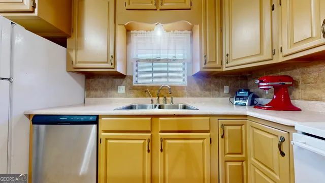 a kitchen with stainless steel appliances granite countertop a sink and cabinets