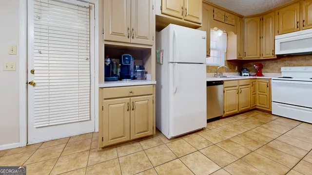 a kitchen with cabinets and appliances
