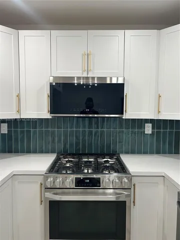 a kitchen with a sink and large window