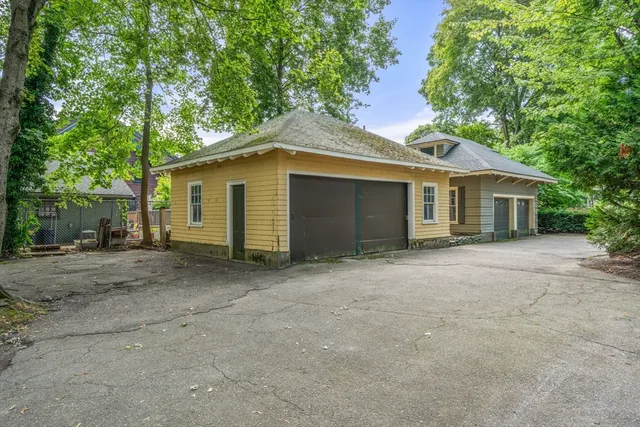 a view of a house with a yard and large tree