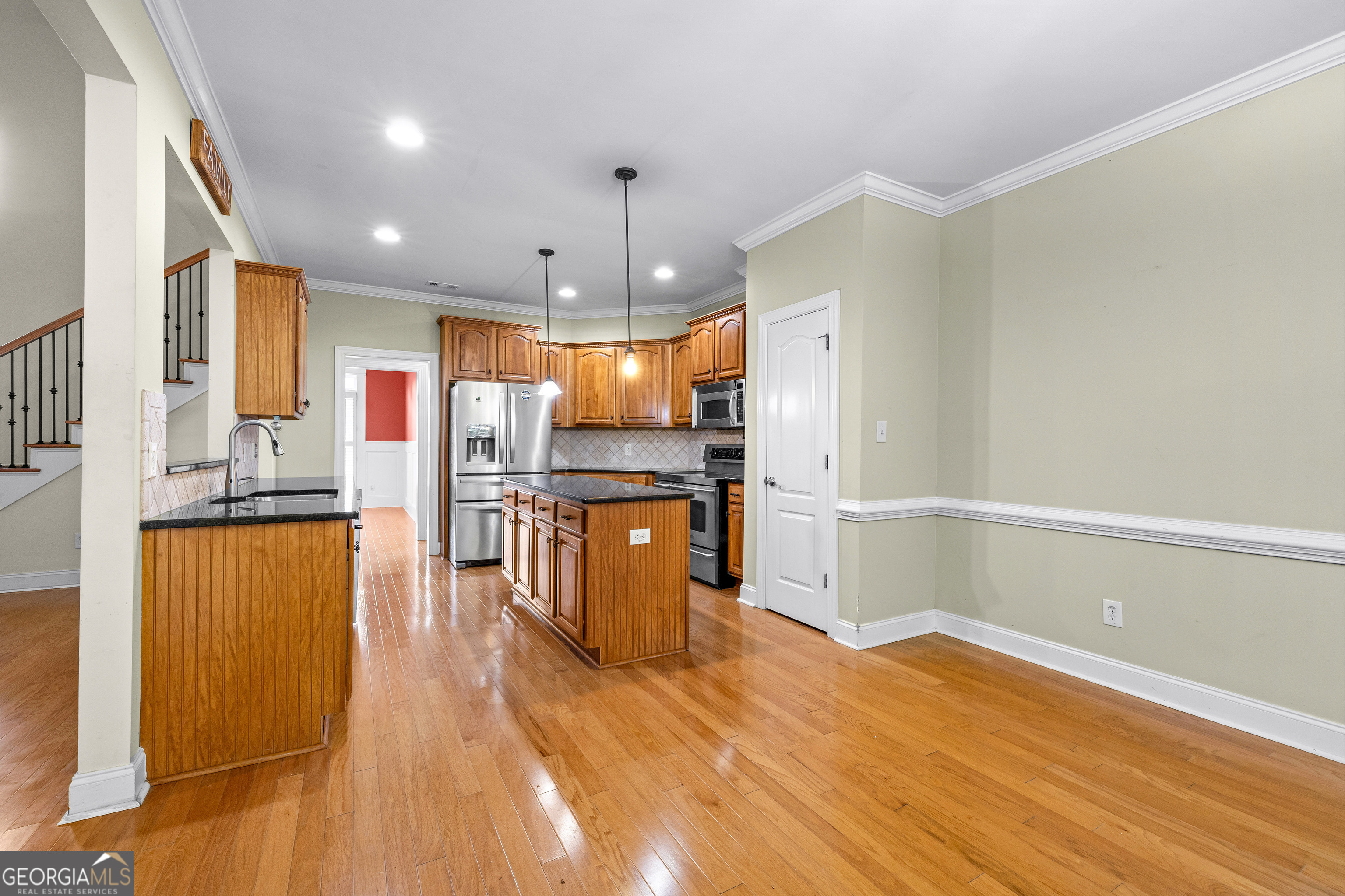 120 Shankhill Ridge Tyrone, GA 30290 - Photo 17 of 54 a kitchen with stainless steel appliances granite countertop a refrigerator a stove oven a sink dishwasher and white cabinets with wooden floor