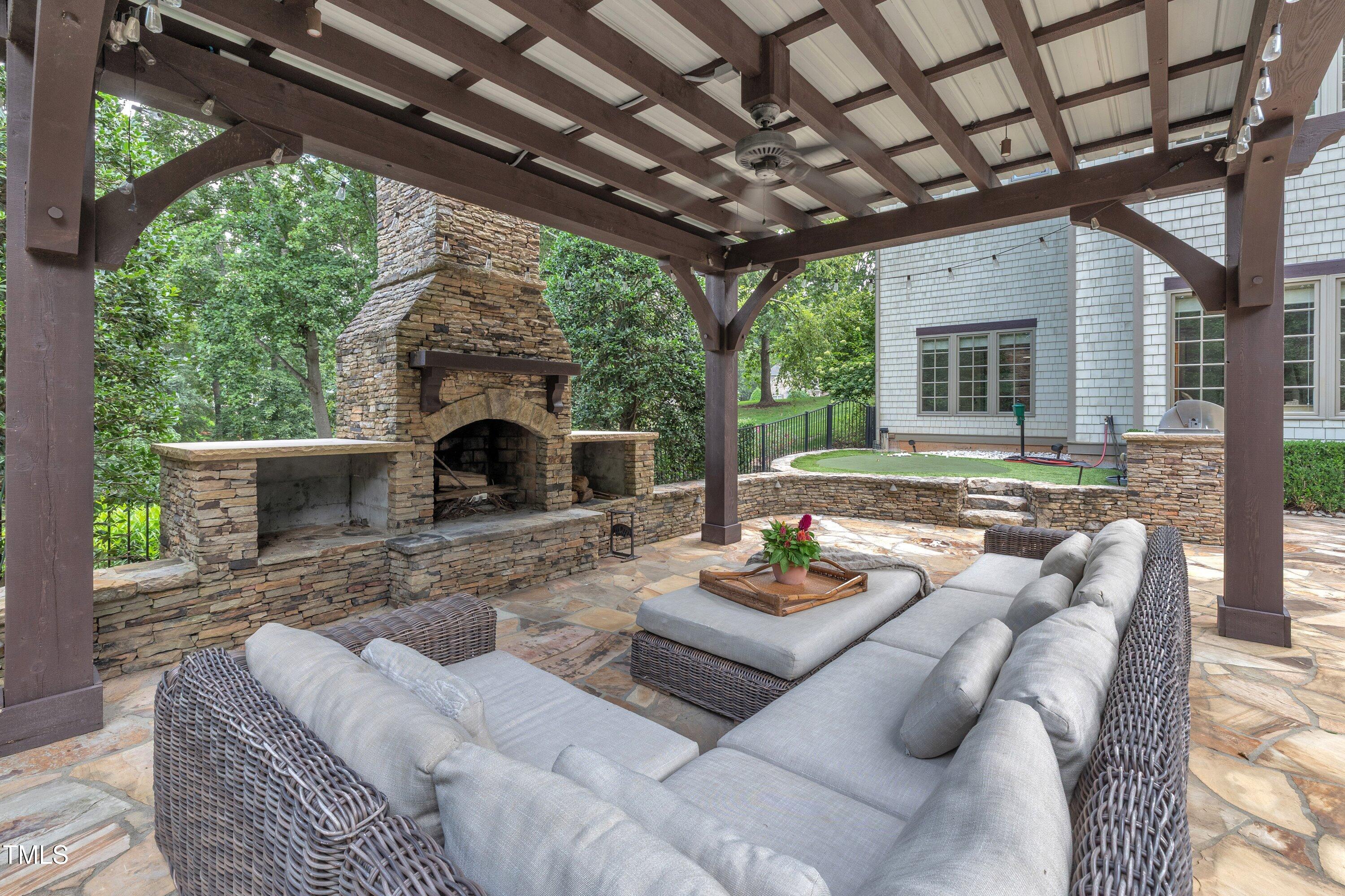 1112 Stone Kirk Drive Raleigh, NC 27614 - Photo 18 of 100 a view of a patio with couches chairs and a fireplace
