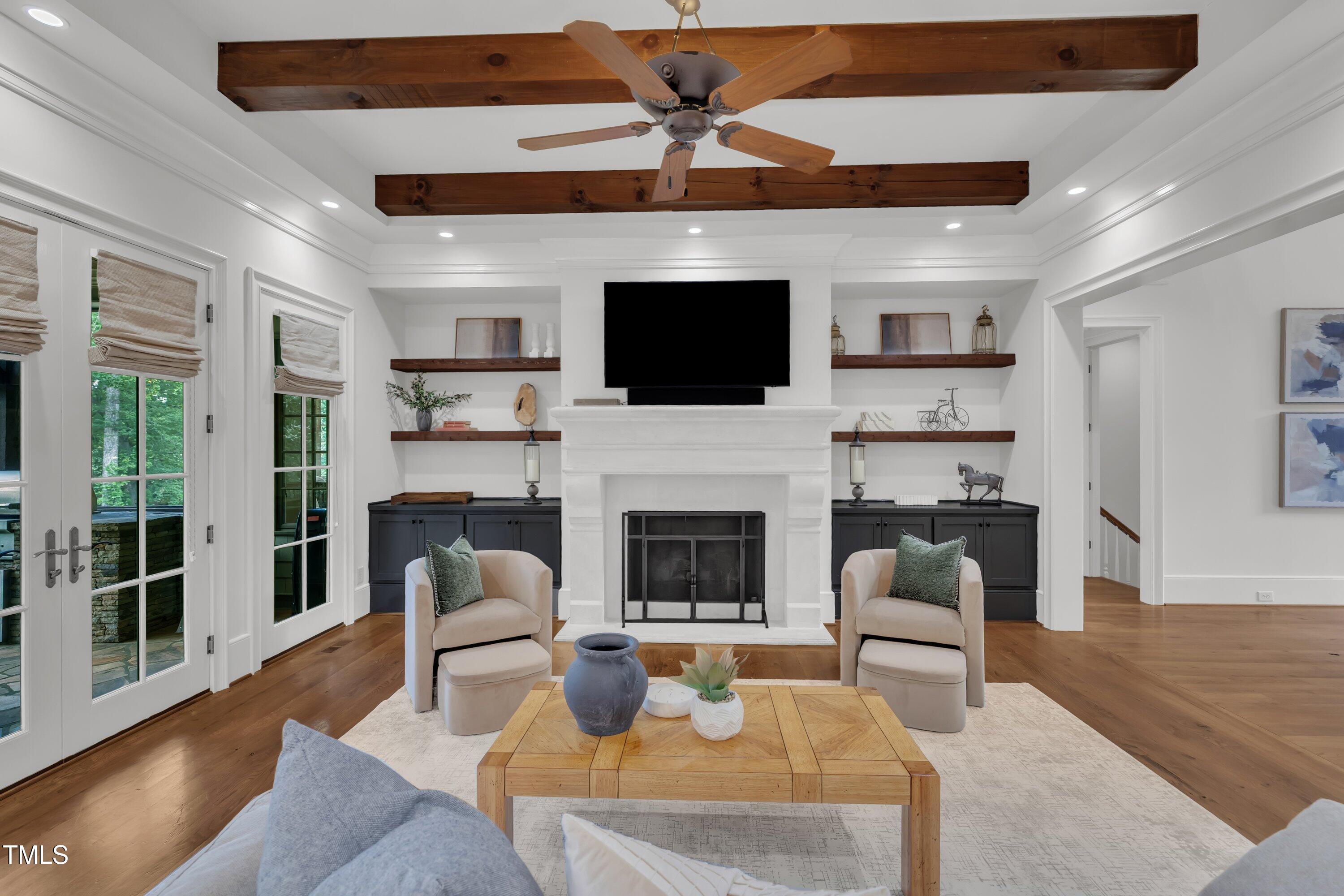 1112 Stone Kirk Drive Raleigh, NC 27614 - Photo 41 of 100 a living room with furniture a fireplace and a flat screen tv