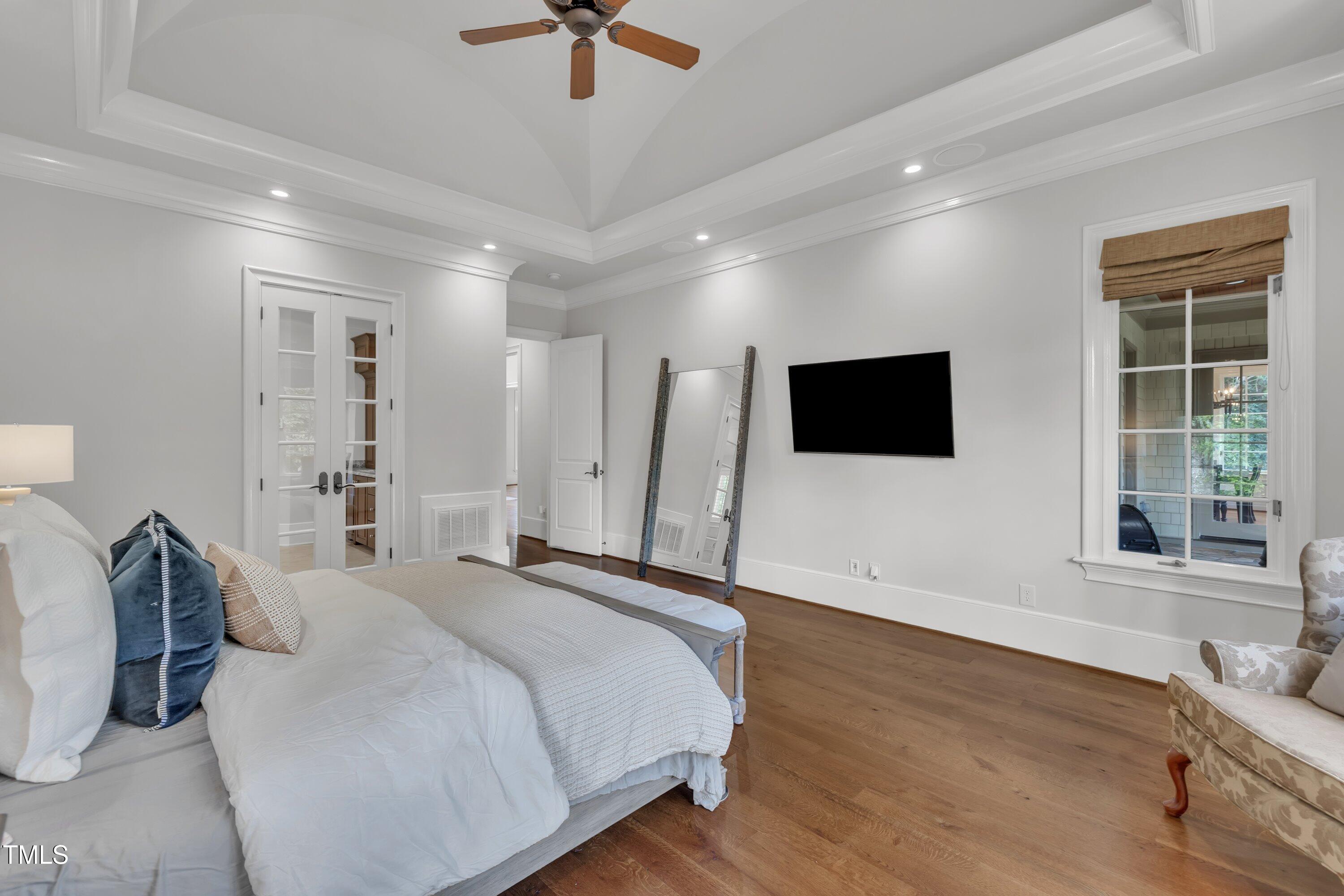 1112 Stone Kirk Drive Raleigh, NC 27614 - Photo 49 of 100 a bedroom with a bed tv and a window