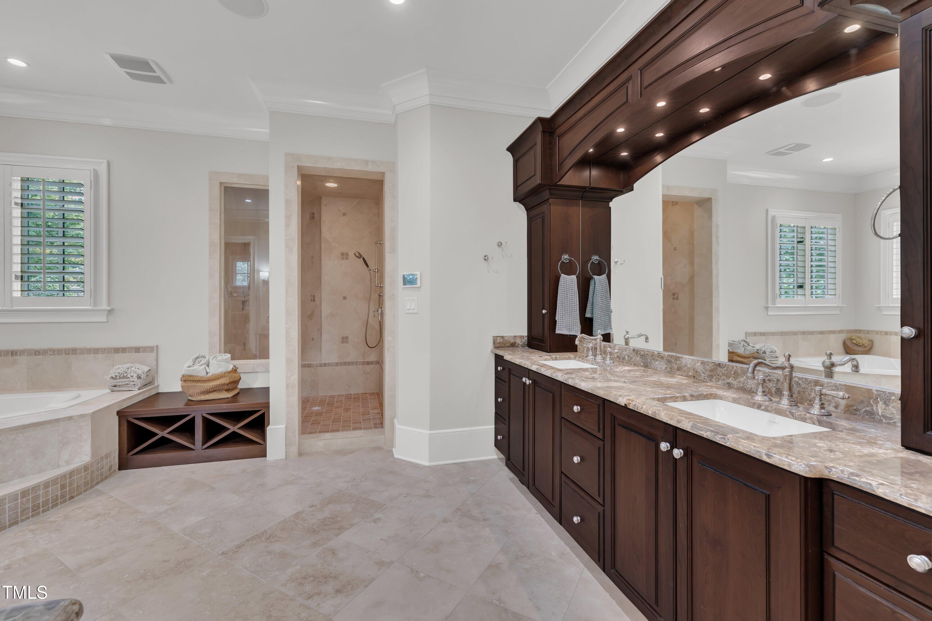 1112 Stone Kirk Drive Raleigh, NC 27614 - Photo 54 of 100 a spacious bathroom with a granite countertop sink a mirror and a bathtub