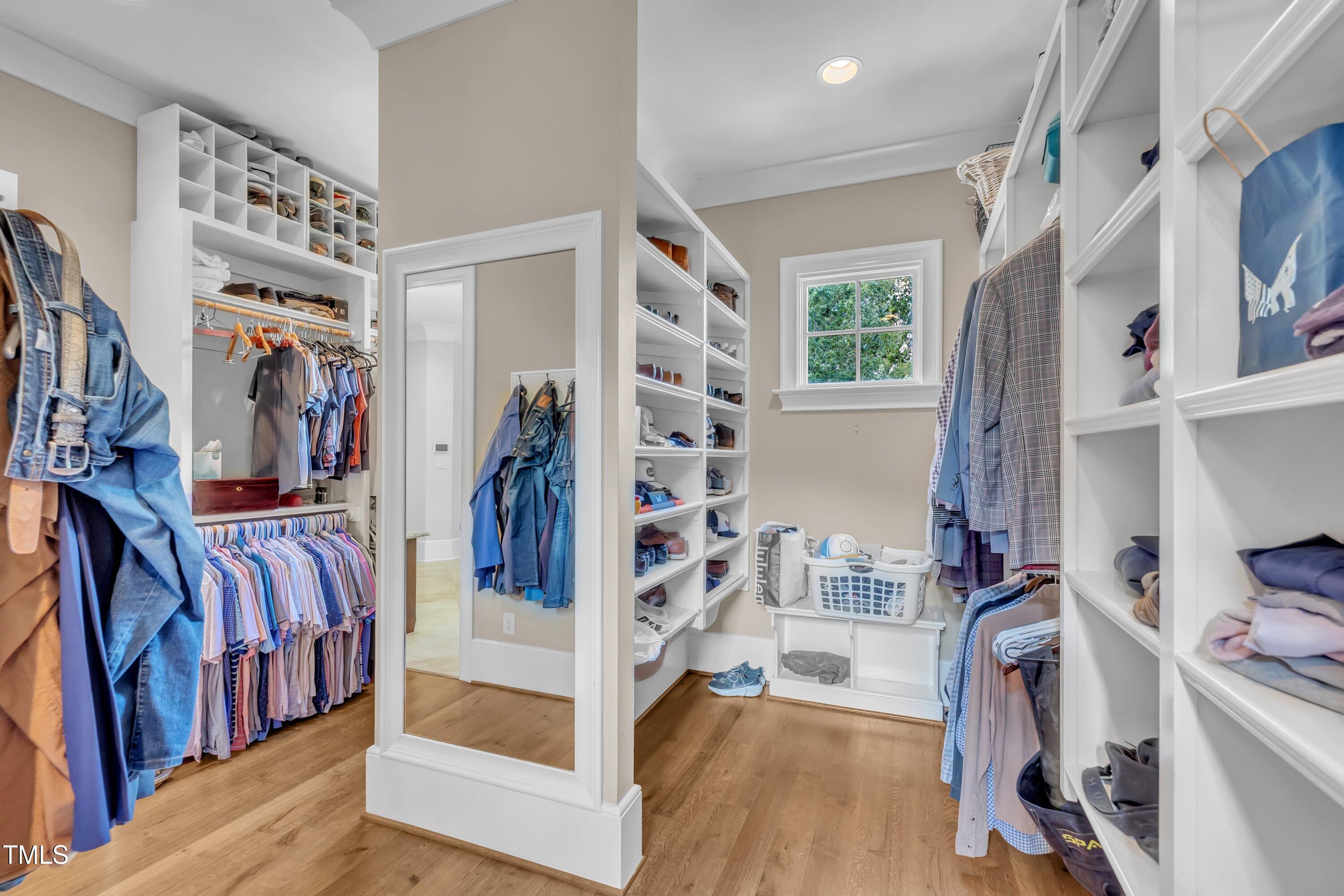 1112 Stone Kirk Drive Raleigh, NC 27614 - Photo 56 of 100 a view of walk in closet with clothes and shoes