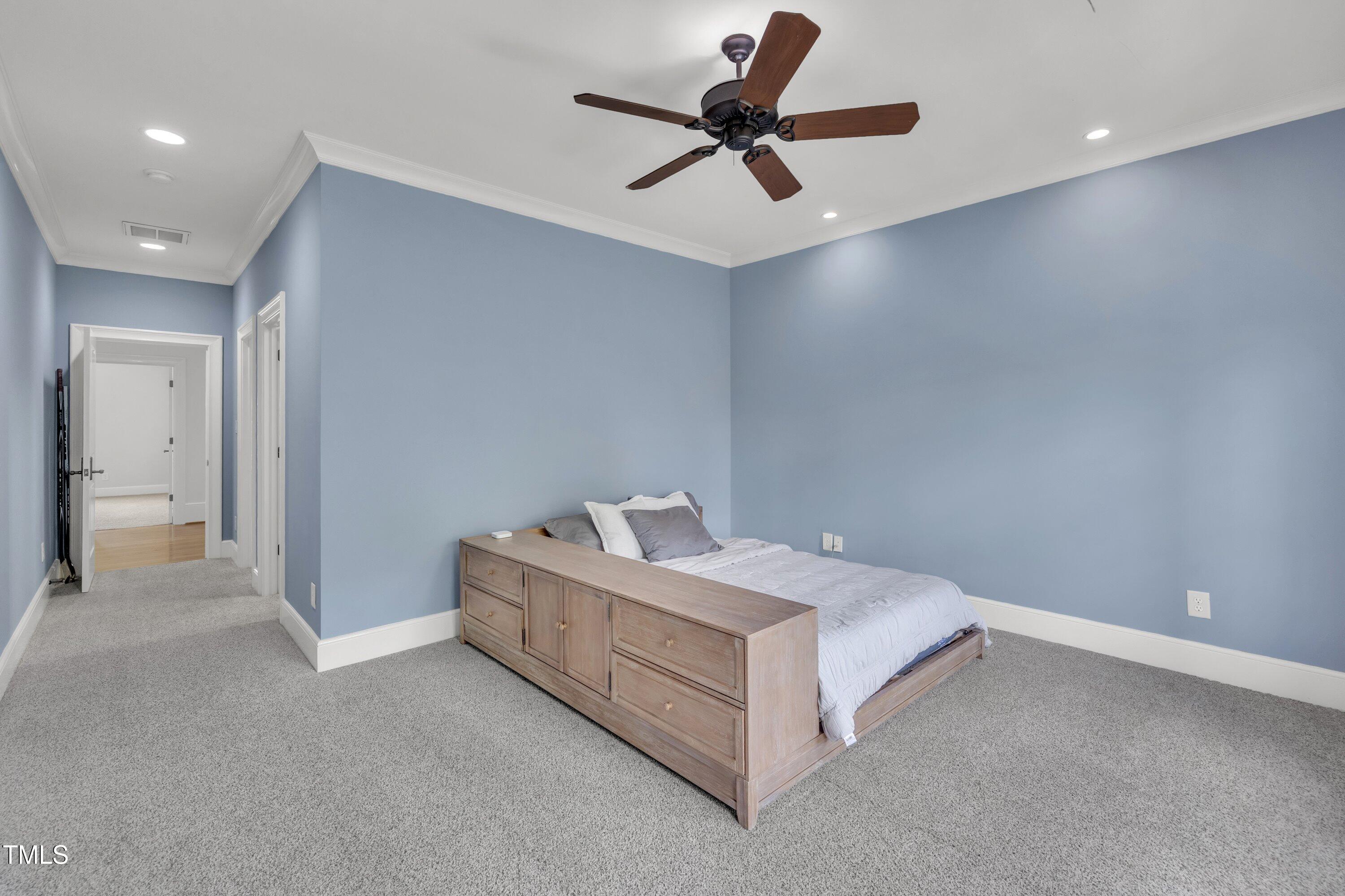 1112 Stone Kirk Drive Raleigh, NC 27614 - Photo 59 of 100 a room with a bed and a ceiling fan