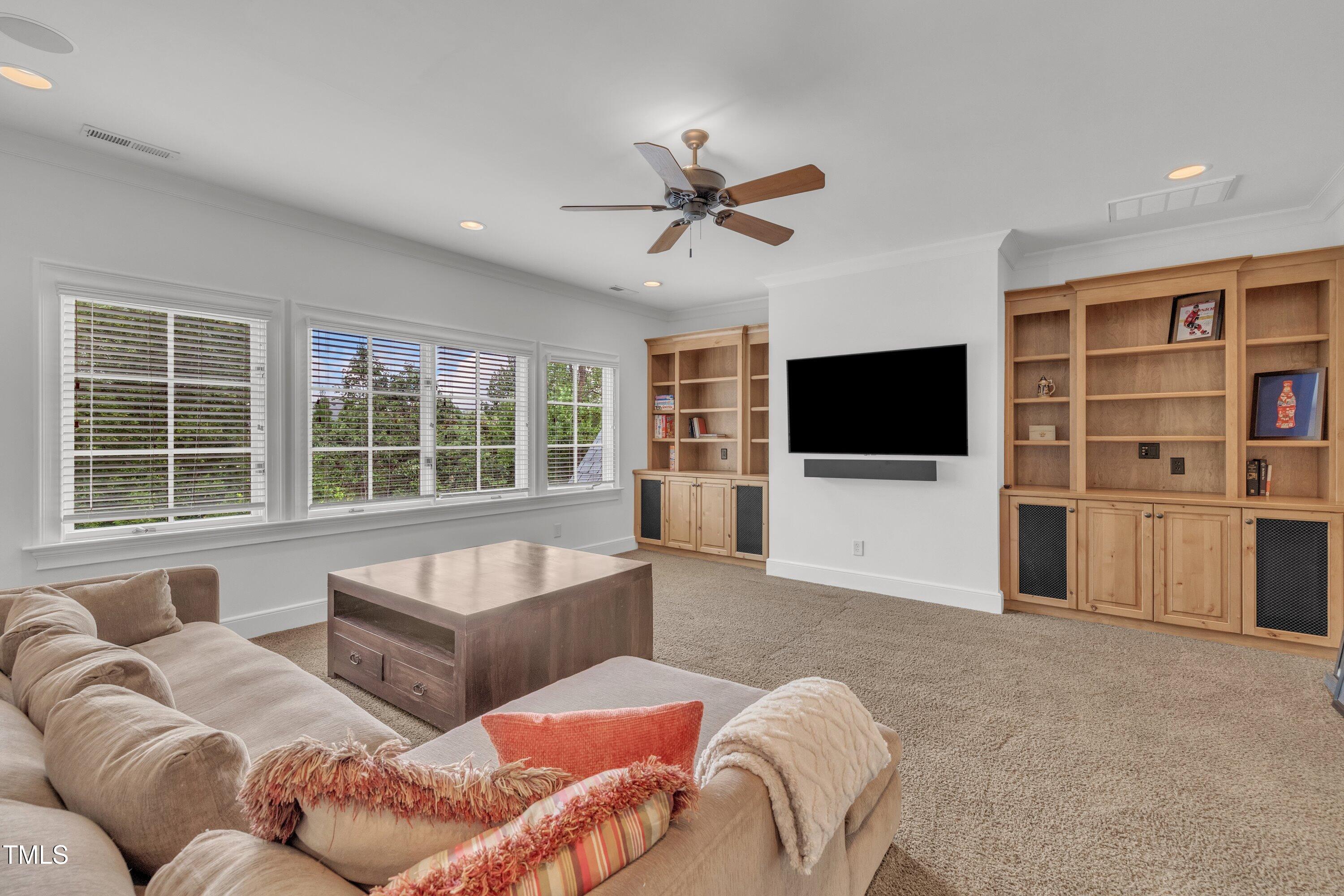 1112 Stone Kirk Drive Raleigh, NC 27614 - Photo 61 of 100 a living room with furniture and a flat screen tv