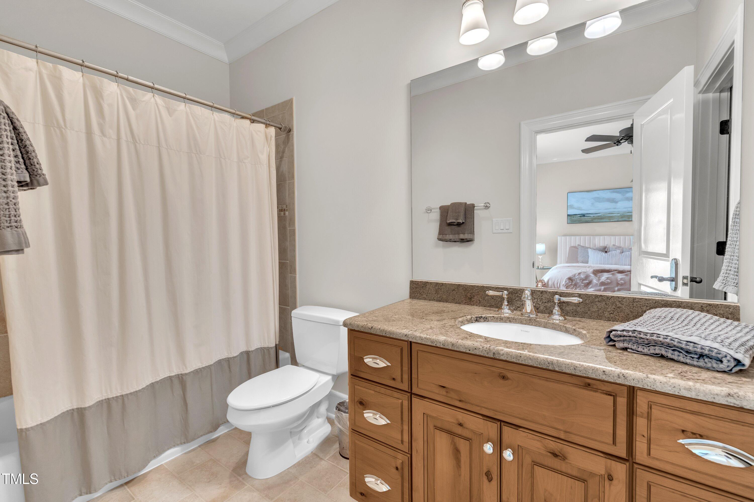 1112 Stone Kirk Drive Raleigh, NC 27614 - Photo 69 of 100 a bathroom with a granite countertop sink toilet a mirror and a shower