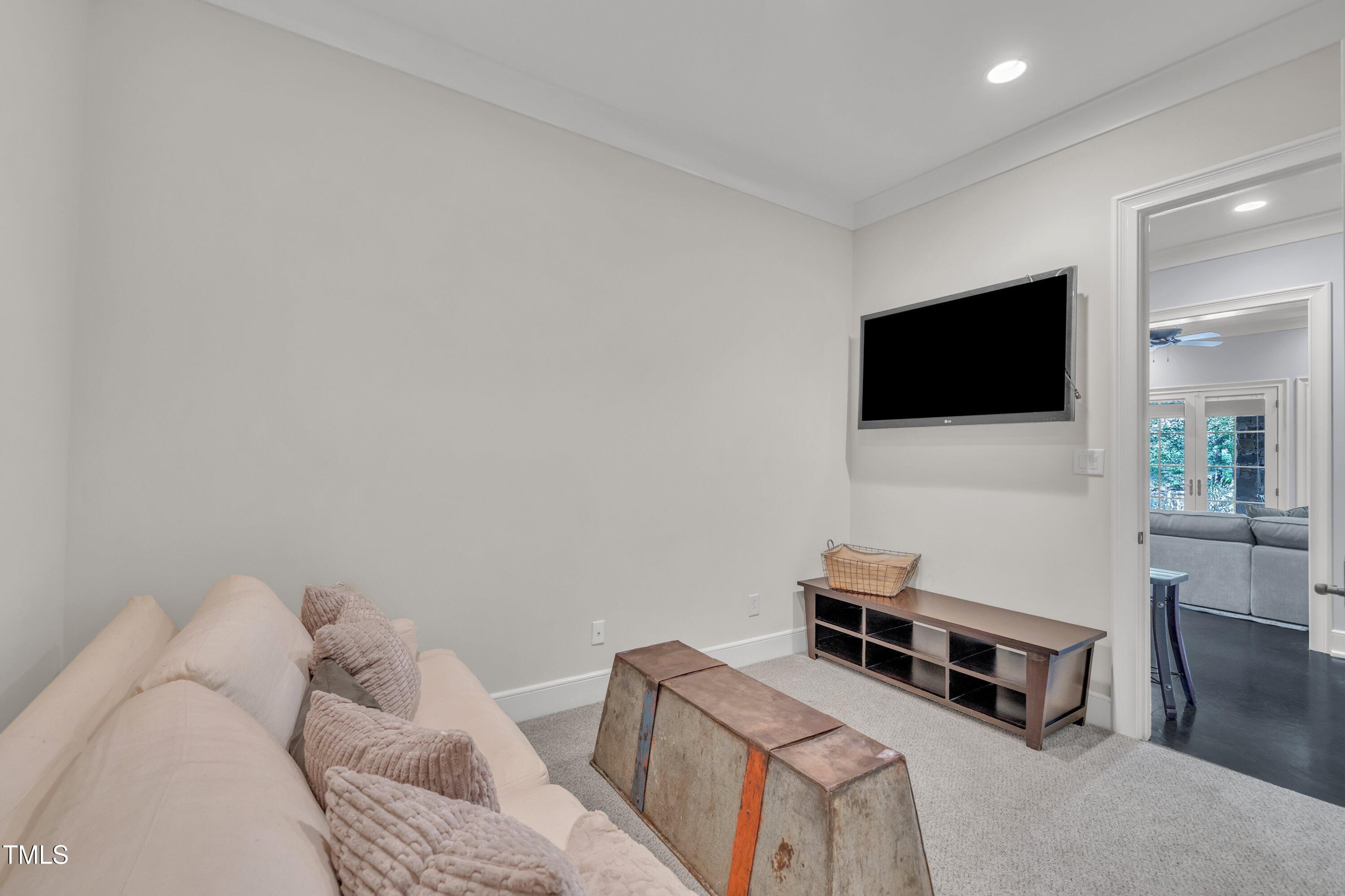 1112 Stone Kirk Drive Raleigh, NC 27614 - Photo 78 of 100 a living room with furniture and a flat screen tv