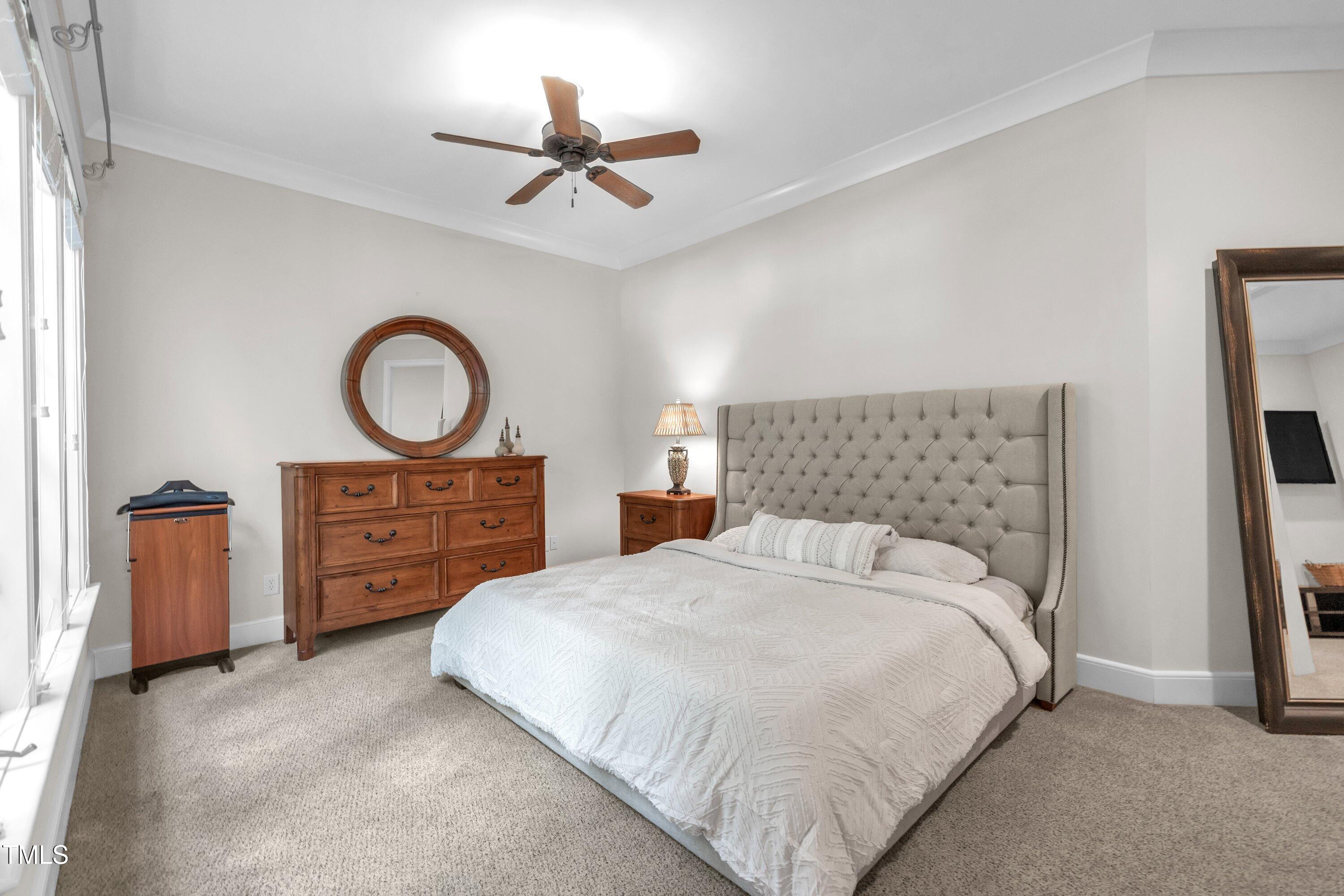 1112 Stone Kirk Drive Raleigh, NC 27614 - Photo 79 of 100 a bedroom with a bed closet and flat tv screen