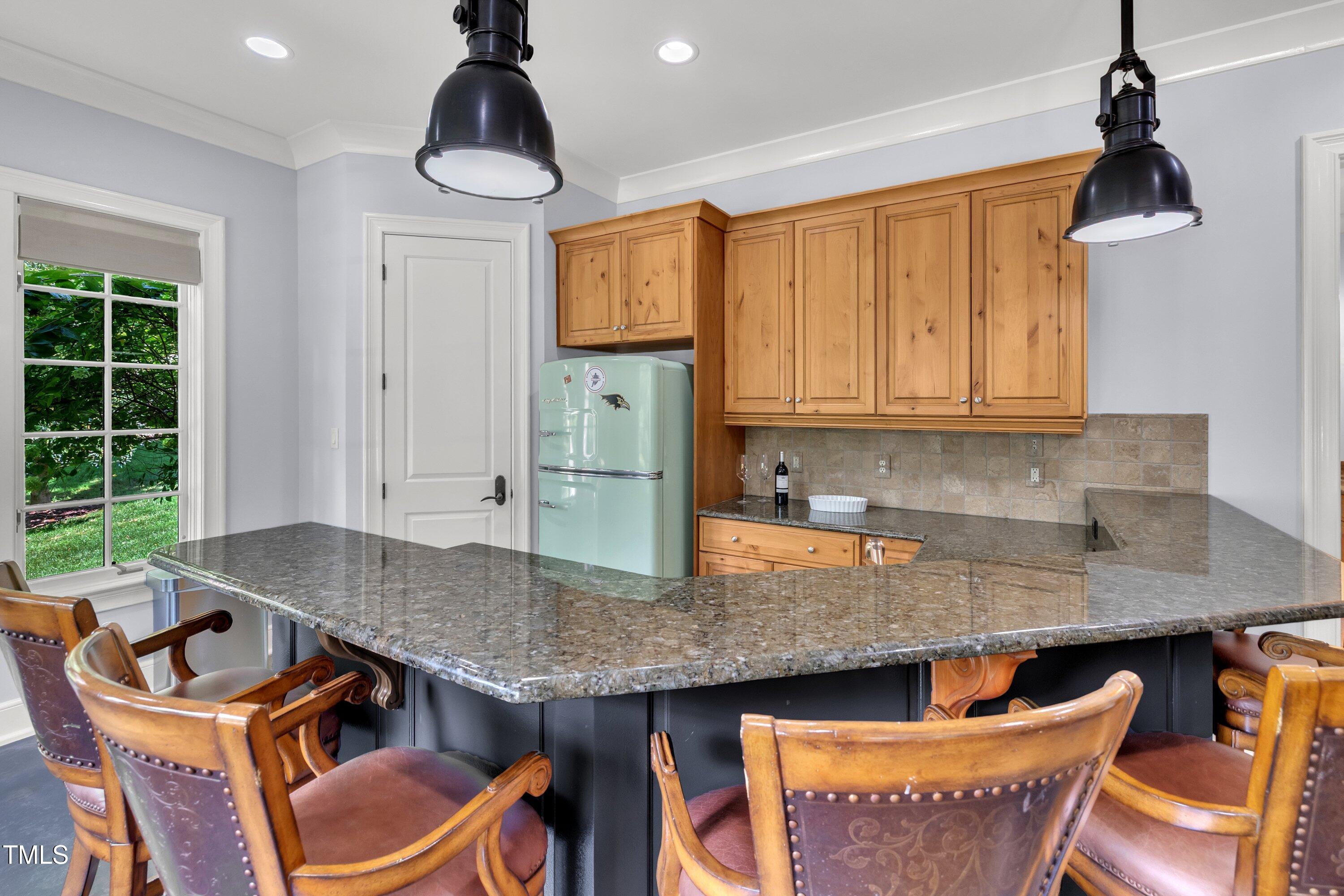 1112 Stone Kirk Drive Raleigh, NC 27614 - Photo 85 of 100 a kitchen with granite countertop a stove a sink and a dining table chair