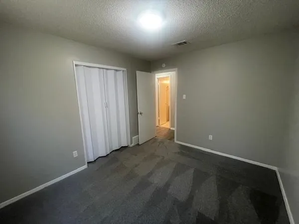 en empty room with windows and fan