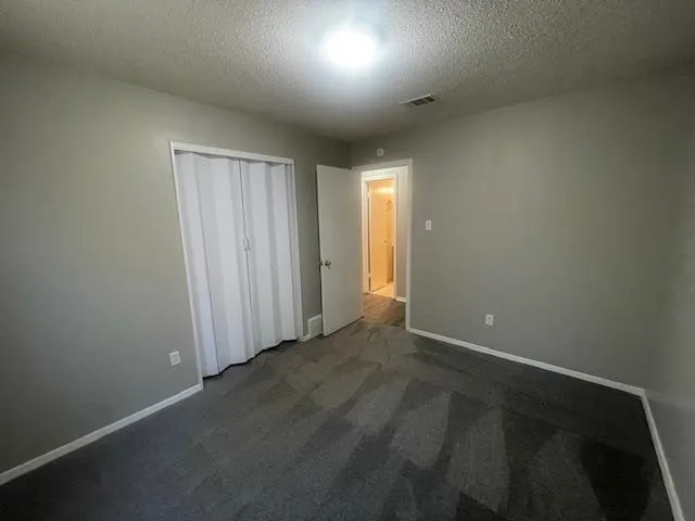 en empty room with windows and fan