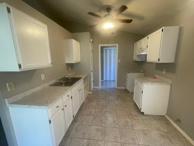 a view of a kitchen with a sink and a window