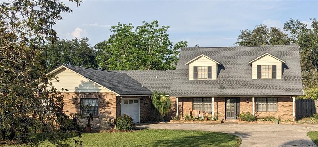6161 Albeth Road Orlando, FL 32810 - Photo 1 of 1 a front view of a house with a yard