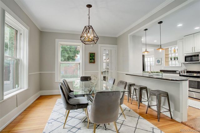 a view of a dining room with furniture wooden floor and chandelier