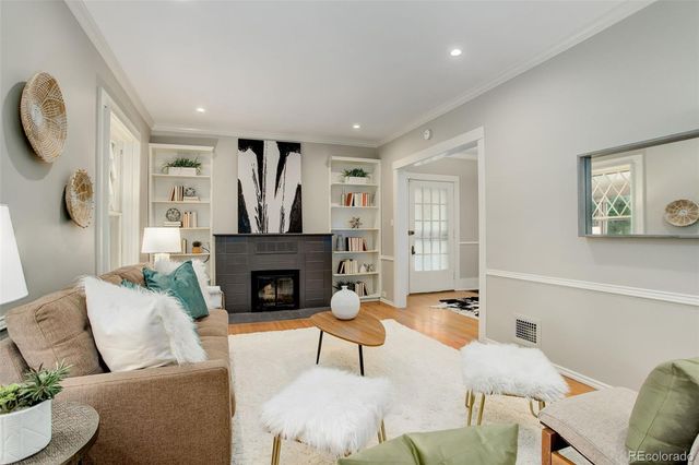 a living room with furniture a fireplace and a table