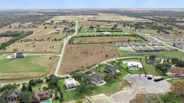 an aerial view of a house with a lake view