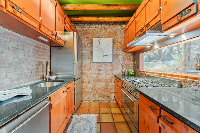 a bath room with a sink and large window